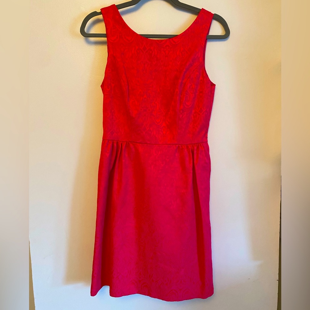 Erin fuscia fit and flare with back cutouts and bow detail w side zipper